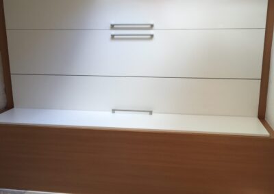 L-shaped wardrobe with fitted doors and handles