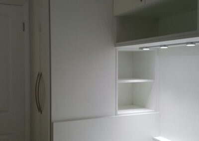 finished white cabin bed with storage bridging units and lighting